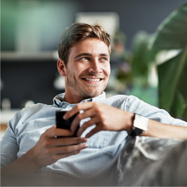 man smiling while on phone