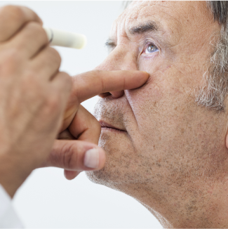 Close-up of old man having his eye tested