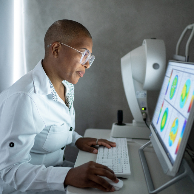 Man in lab coat working on computer